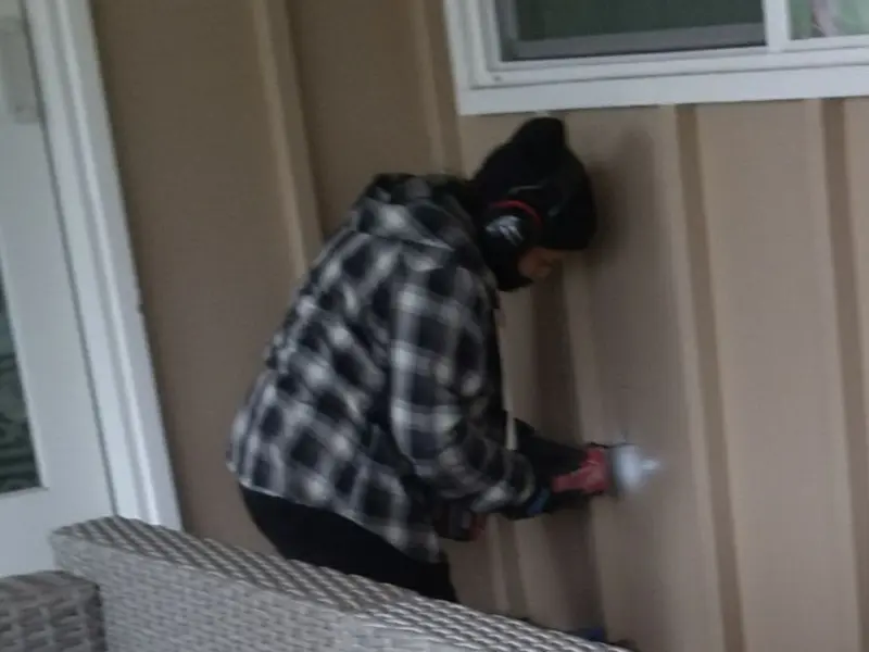 Professional electrician installing an exterior outlet in Hector