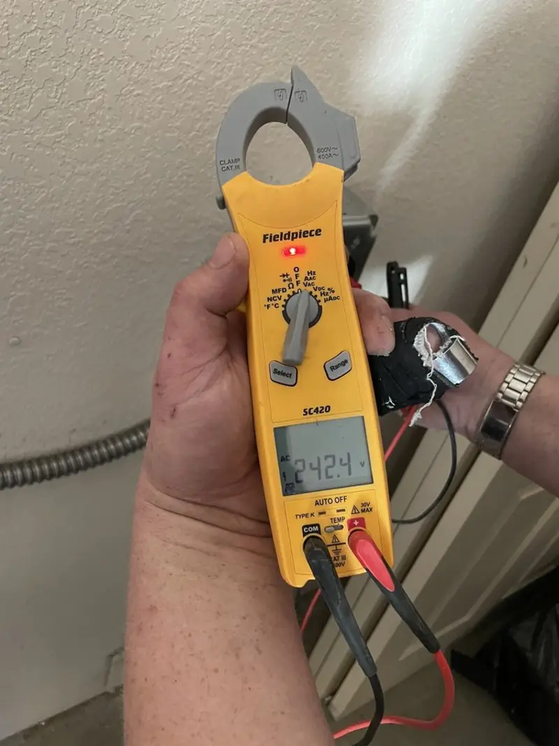 Voltage testing with clamp meter during Electrical Installation Services in Hector